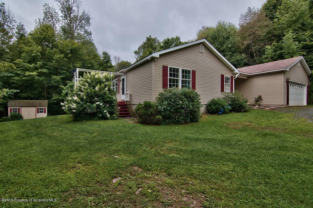 212 Summit Woods Road Moscow, PA 18444 - Photo 60 of 68 a front view of house with yard and green space