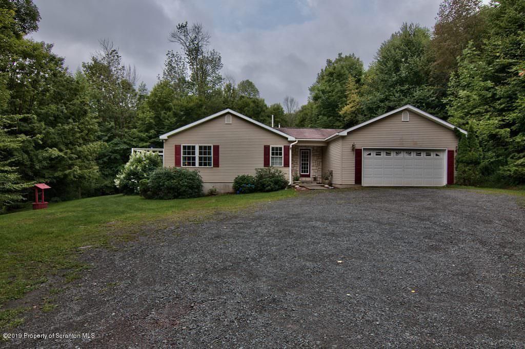 212 Summit Woods Road Moscow, PA 18444 - Photo 67 of 68 a view of a house with a yard and large trees