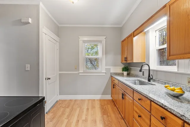 a kitchen with a sink a window and cabinets