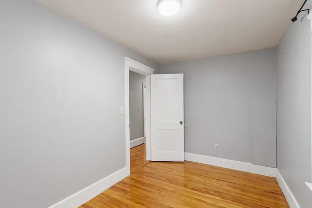 a view of an empty room and wooden floor