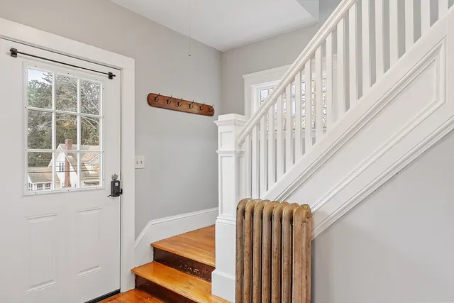 a view of room with wooden floor and stairs