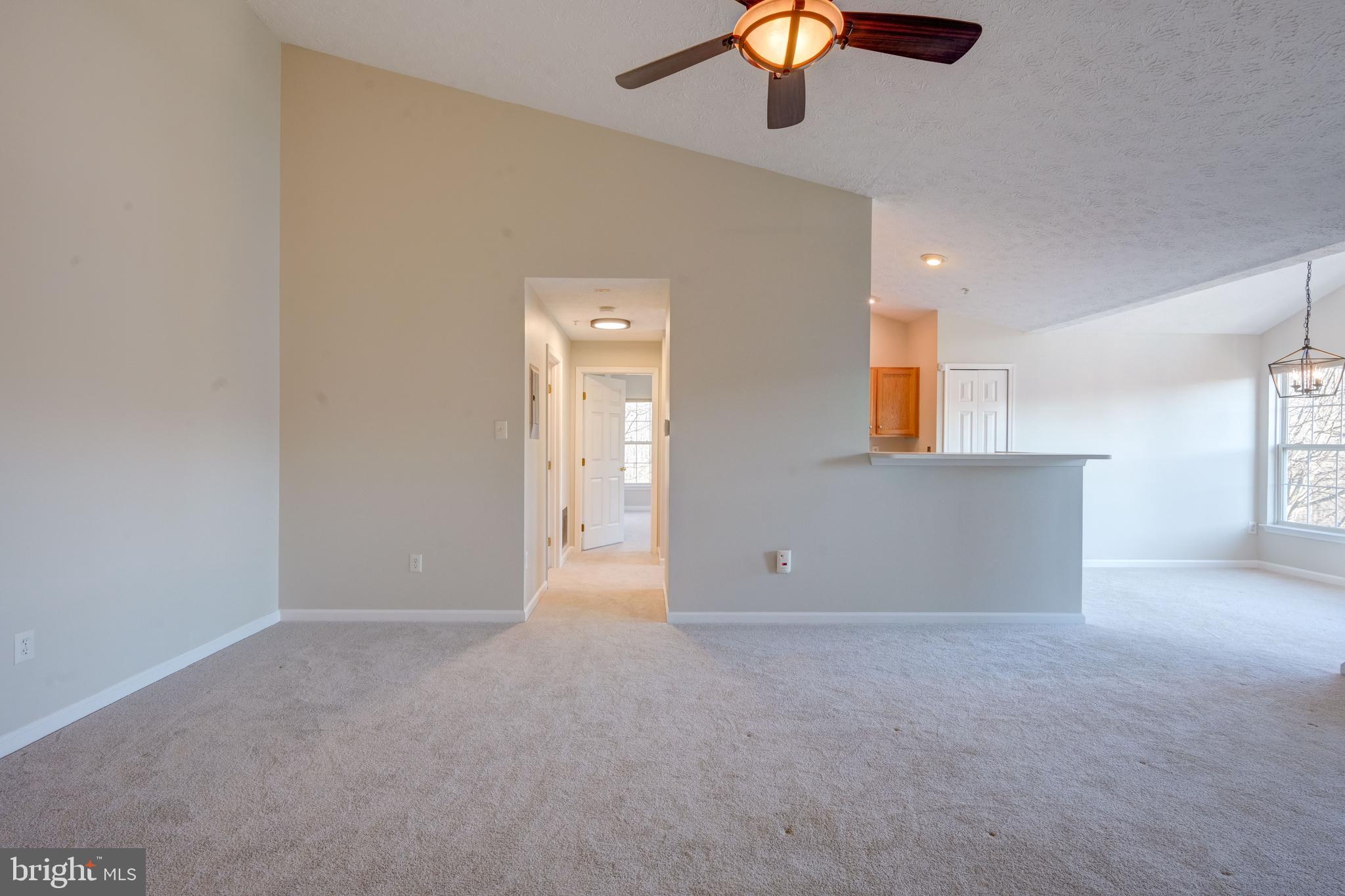 4933 Riders Court, Unit 4933 Owings Mills, MD 21117 - Photo 13 of 32 an empty room with a ceiling fan and window