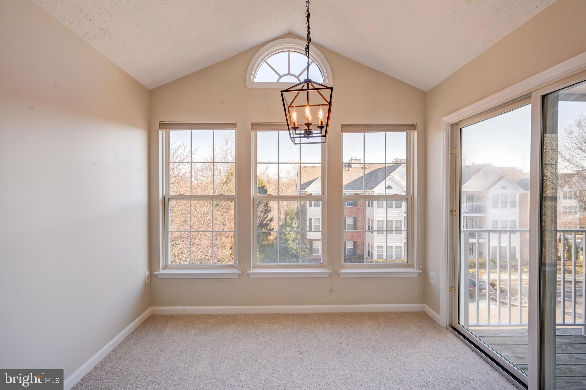 4933 Riders Court, Unit 4933 Owings Mills, MD 21117 - Photo 14 of 32 a view of empty room with wooden floor and fan