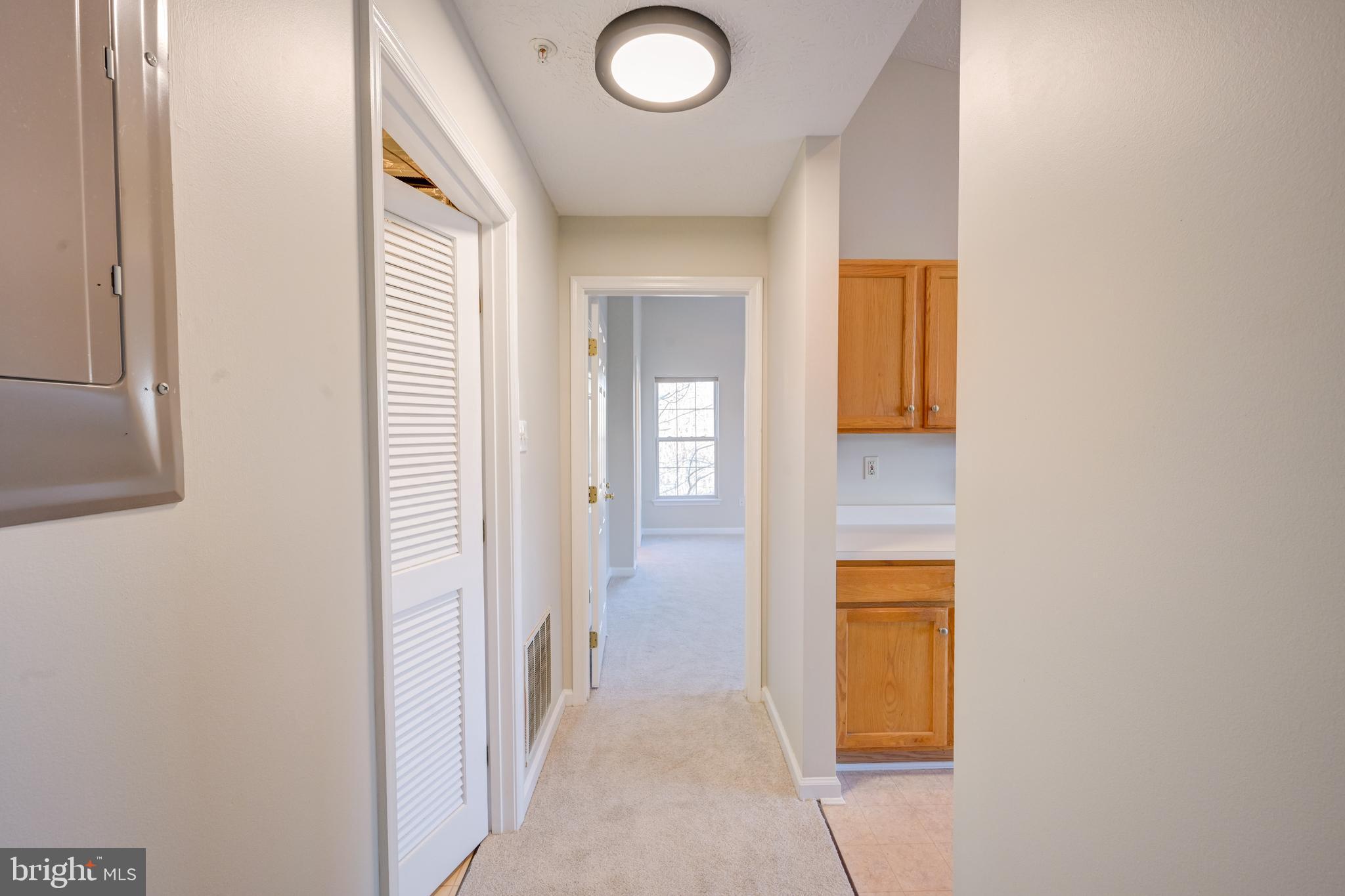 4933 Riders Court, Unit 4933 Owings Mills, MD 21117 - Photo 15 of 32 a view of a hallway with wooden floor and a bathroom