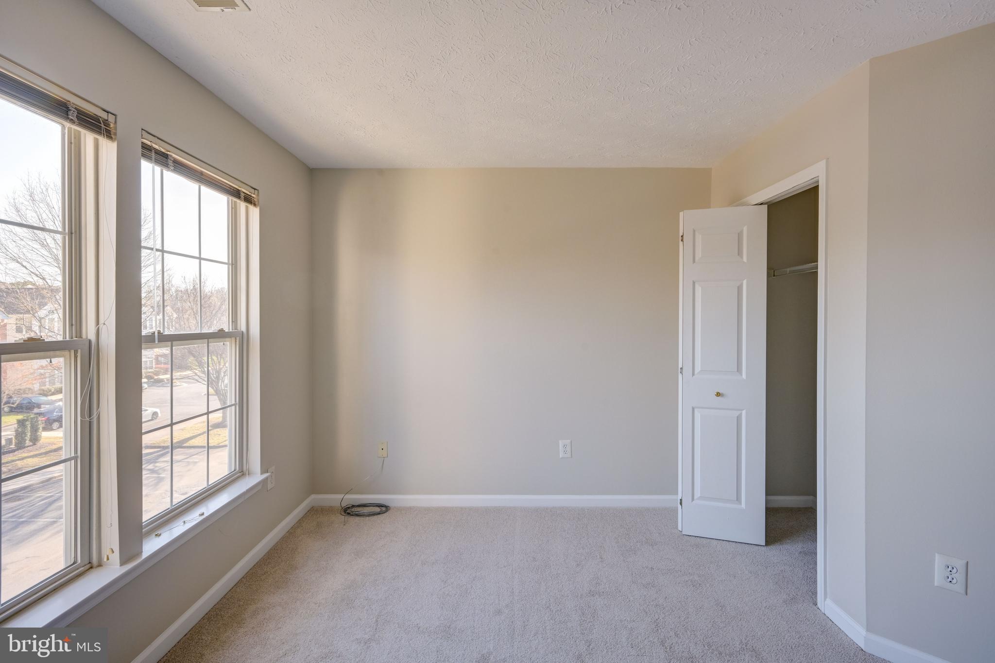 4933 Riders Court, Unit 4933 Owings Mills, MD 21117 - Photo 30 of 32 an empty room with windows