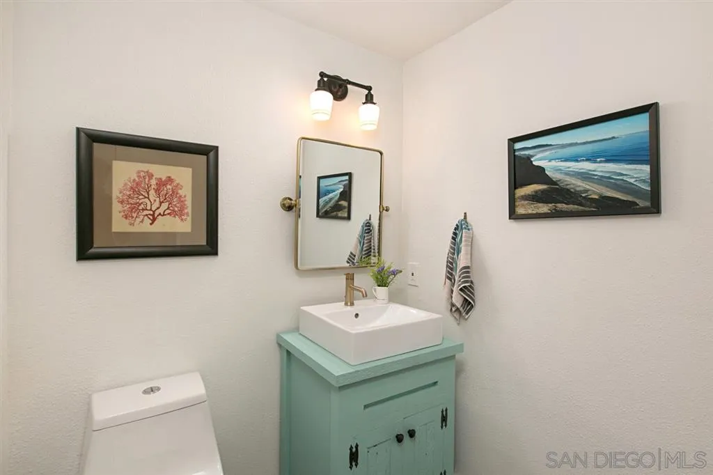 13637 Calais Drive Del Mar, CA 92014 - Photo 13 of 25 a bathroom with a toilet a sink and mirror