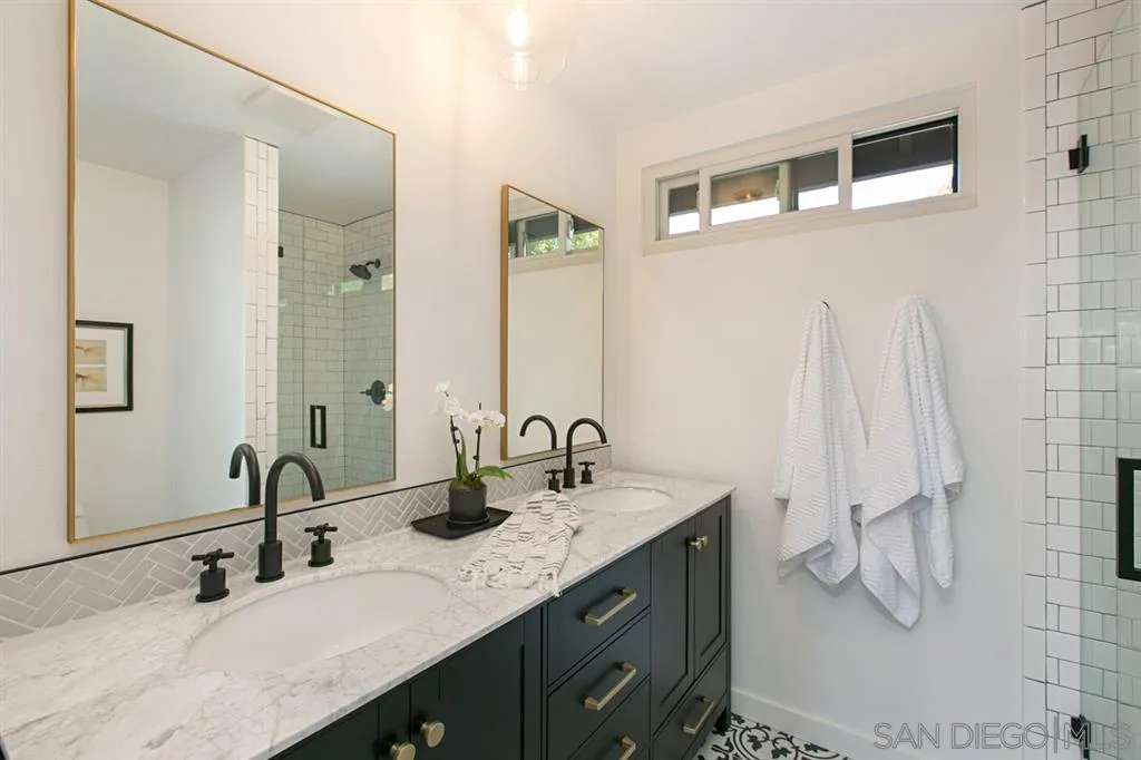 13637 Calais Drive Del Mar, CA 92014 - Photo 16 of 25 a bathroom with a double vanity sink and mirror