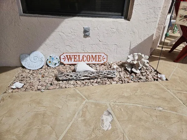 a kitchen with stainless steel appliances granite countertop a dining table chairs a refrigerator and a stove