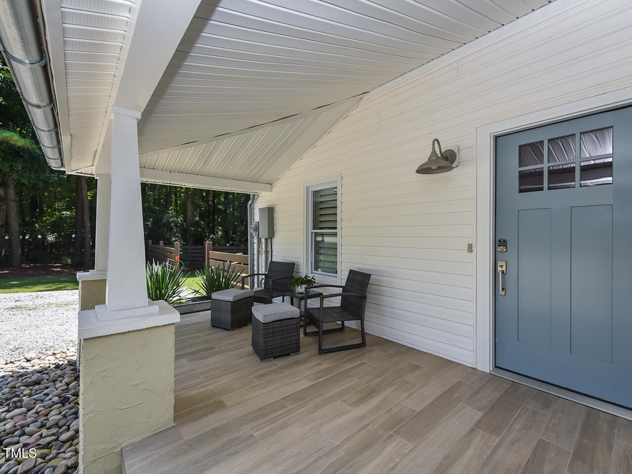 3223 Tryon Road Raleigh, NC 27603 - Photo 11 of 45 a view of a patio with table and chairs and wooden fence