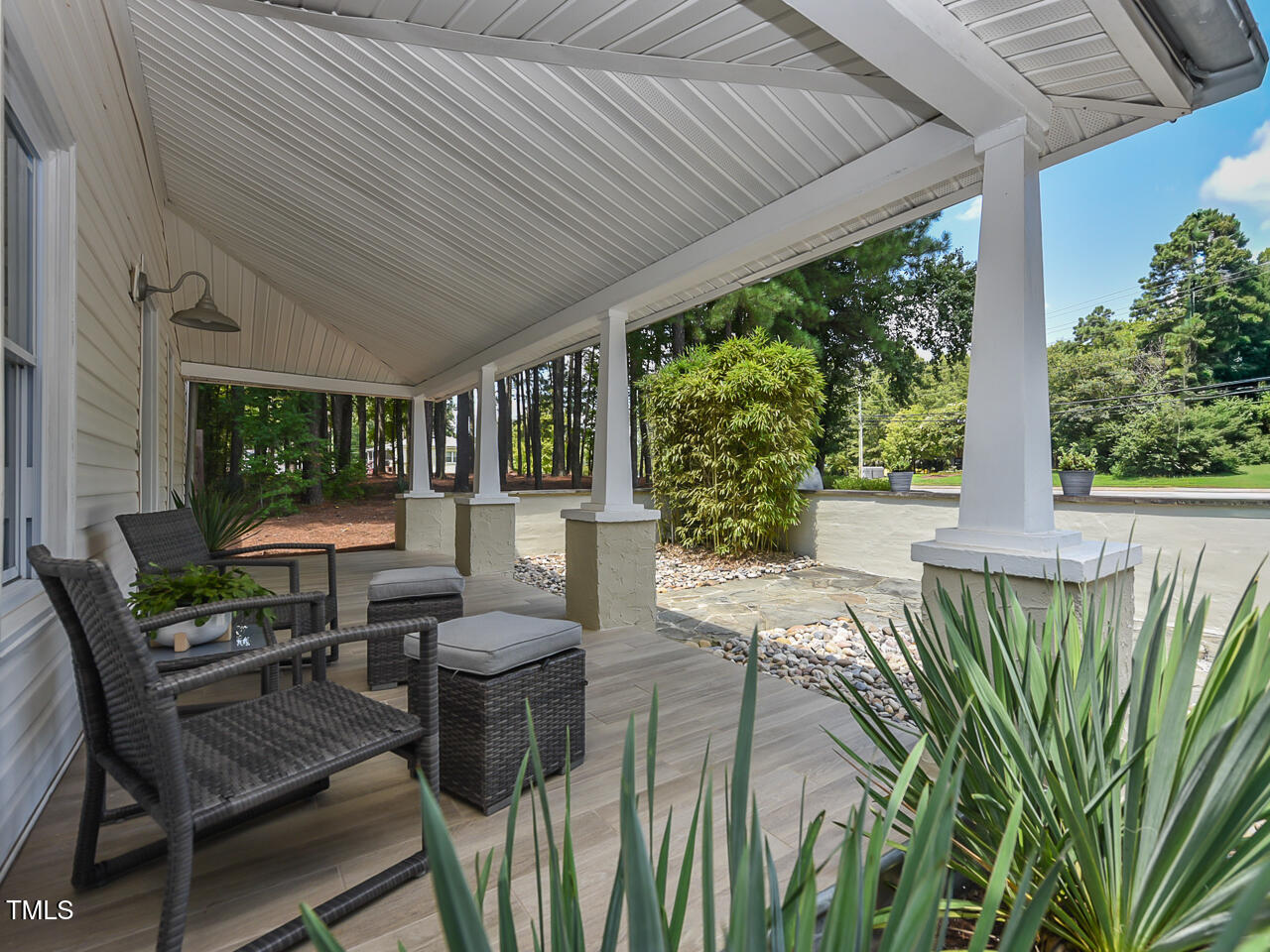 3223 Tryon Road Raleigh, NC 27603 - Photo 12 of 45 a view of a patio with table and chairs potted plants with wooden floor