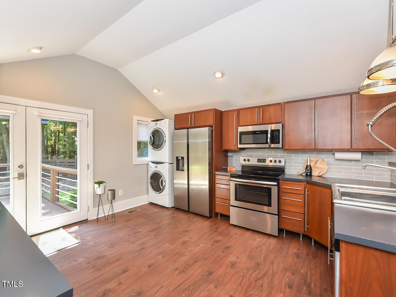 3223 Tryon Road Raleigh, NC 27603 - Photo 14 of 45 a kitchen with stainless steel appliances a stove a sink and a refrigerator