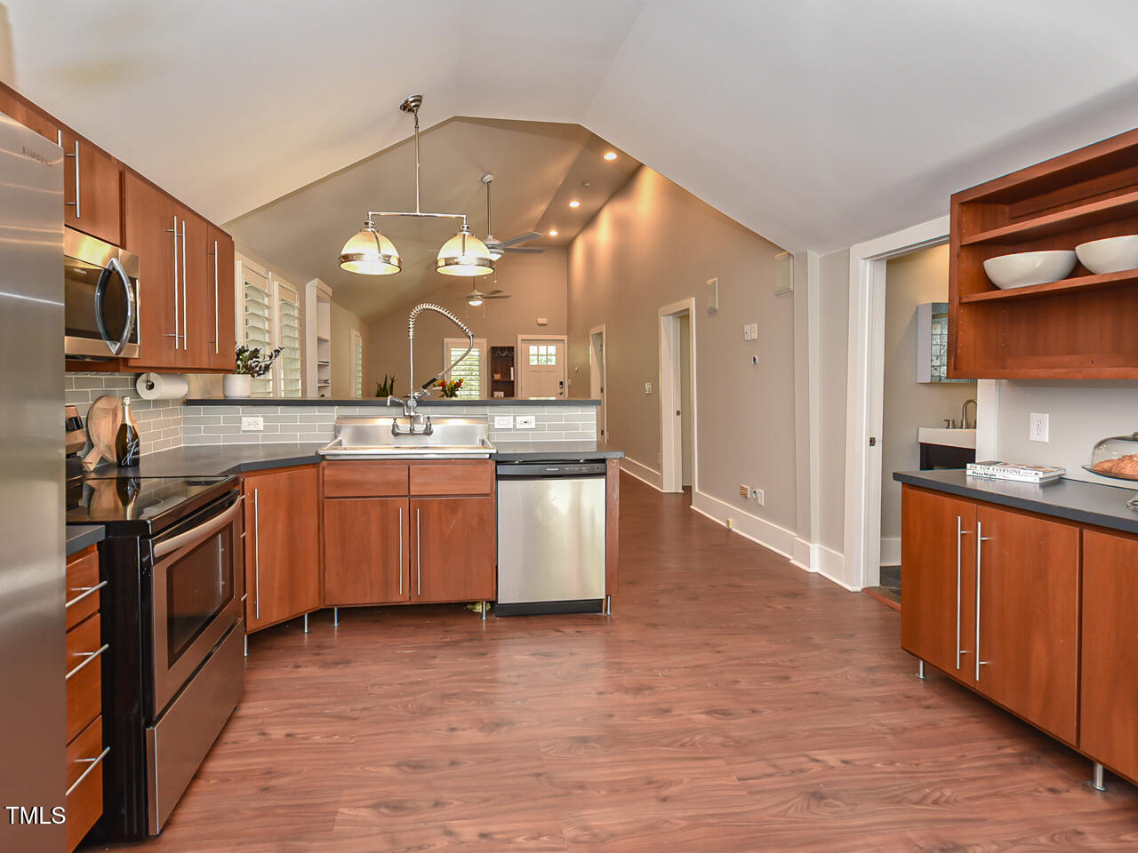 3223 Tryon Road Raleigh, NC 27603 - Photo 16 of 45 a large kitchen with stainless steel appliances granite countertop a stove and a sink