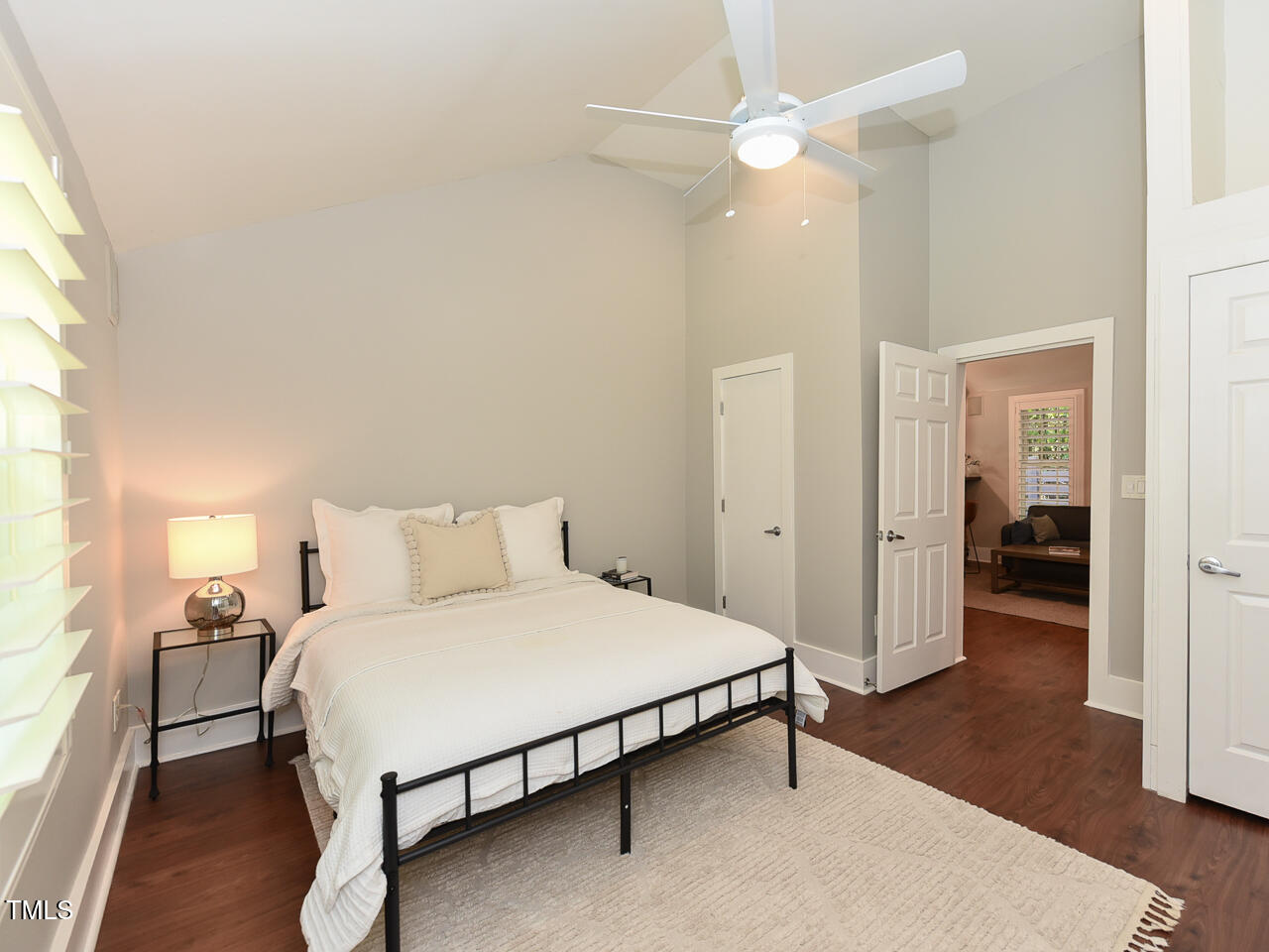 3223 Tryon Road Raleigh, NC 27603 - Photo 24 of 45 a spacious bedroom with a bed and a chandelier