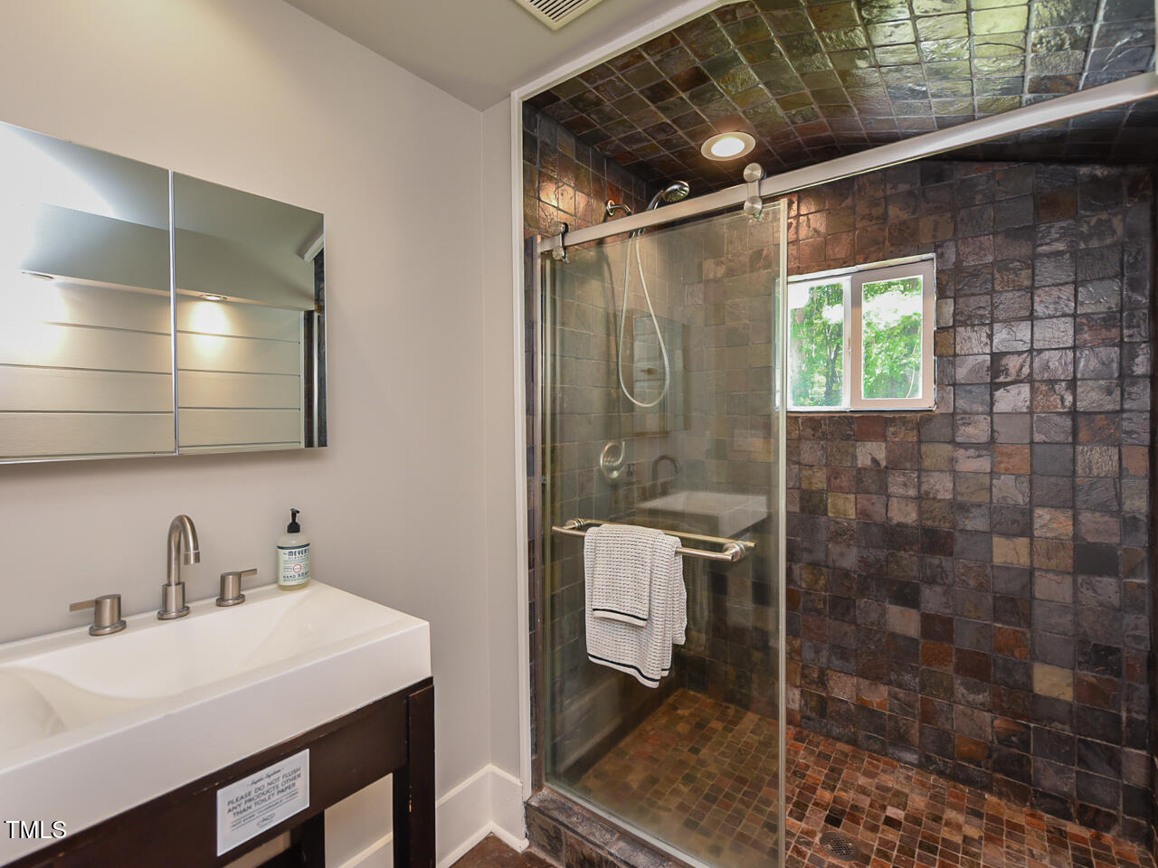 3223 Tryon Road Raleigh, NC 27603 - Photo 27 of 45 a bathroom with a sink shower and a mirror