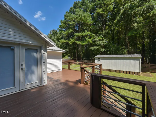 a view of outdoor space with deck and trees