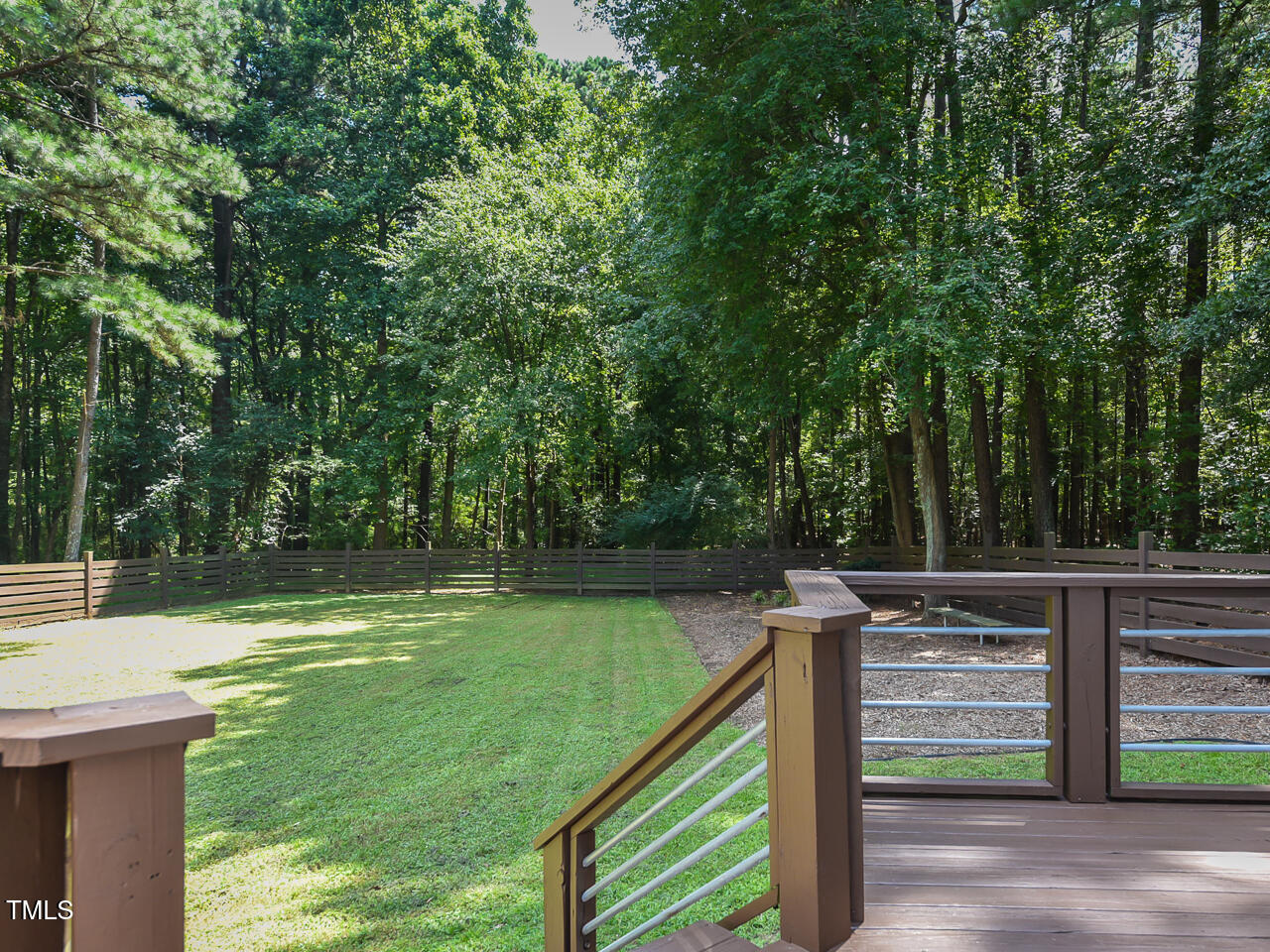 3223 Tryon Road Raleigh, NC 27603 - Photo 32 of 45 a view of a wooden deck and a backyard
