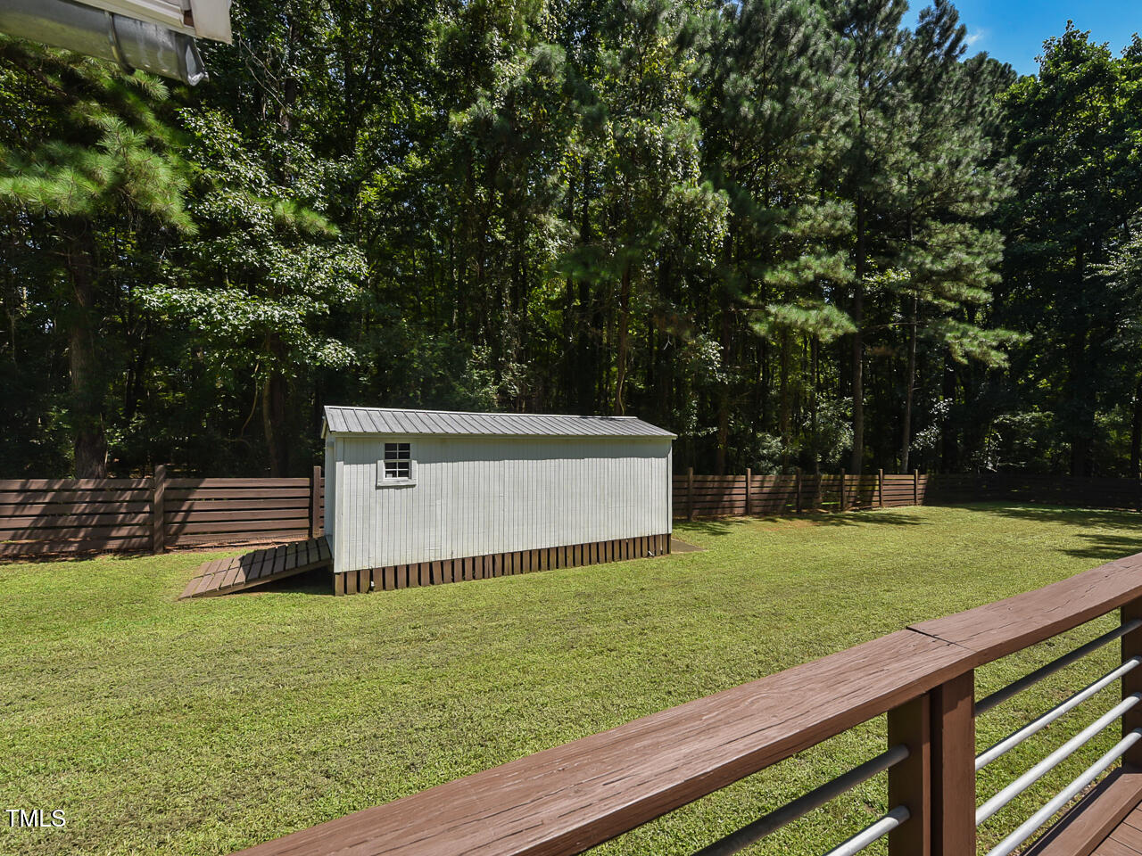 3223 Tryon Road Raleigh, NC 27603 - Photo 34 of 45 a view of a backyard with wooden fence and large trees