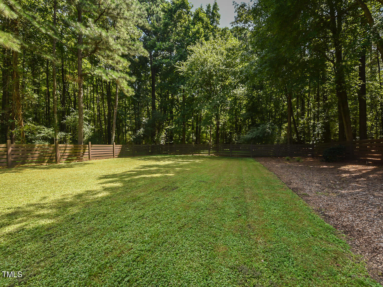 3223 Tryon Road Raleigh, NC 27603 - Photo 37 of 45 a view of outdoor space with deck and trees
