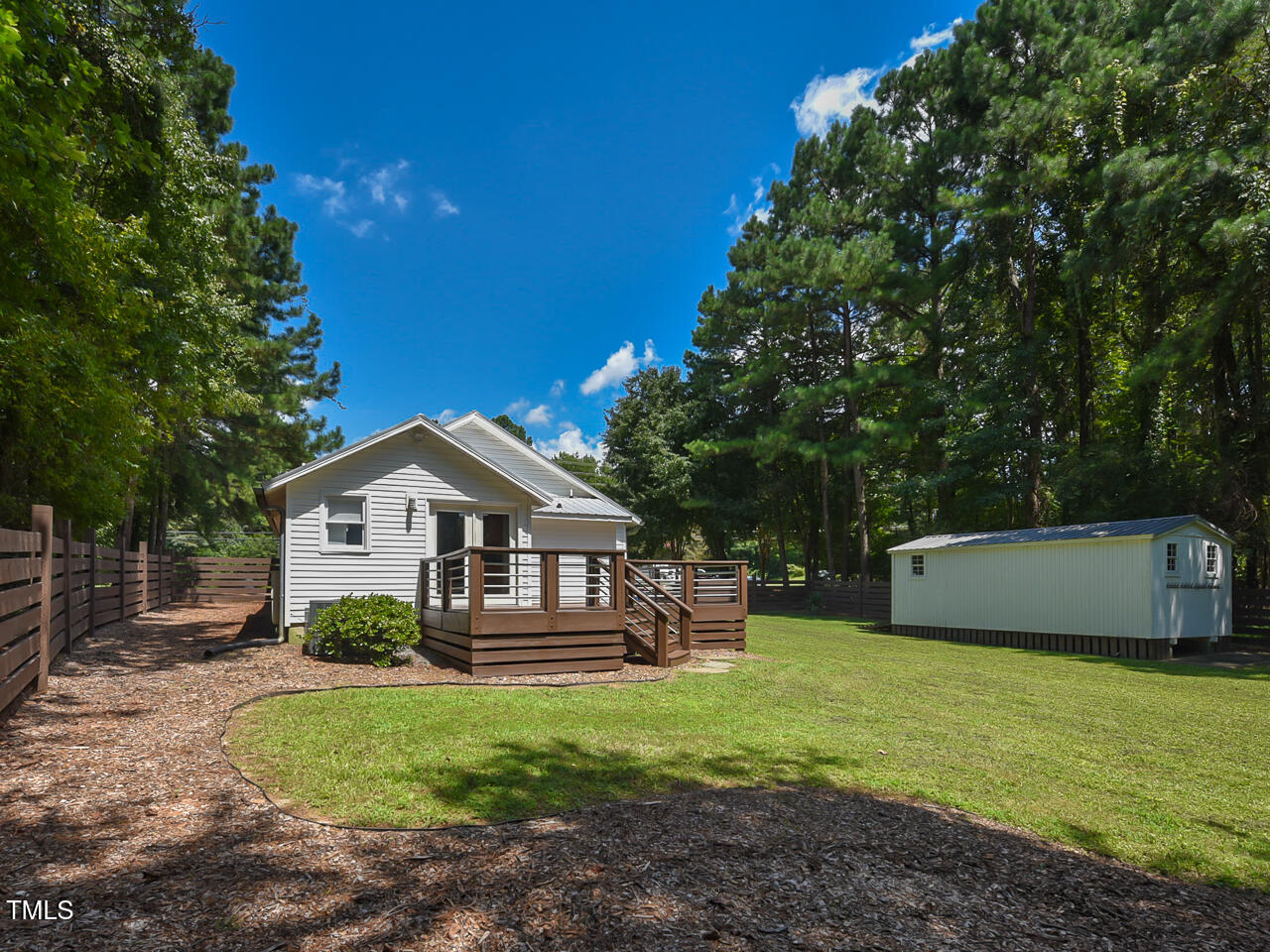 3223 Tryon Road Raleigh, NC 27603 - Photo 39 of 45 a front view of a house with a garden and trees