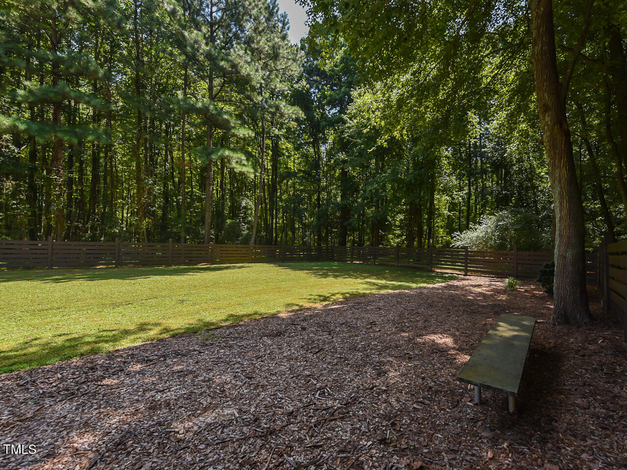 3223 Tryon Road Raleigh, NC 27603 - Photo 43 of 45 a view of a backyard with large trees