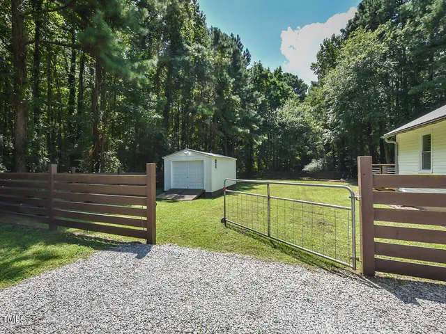 a view of a patio with couches table and chairs and potted plants