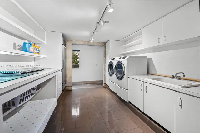a kitchen with sink and large window