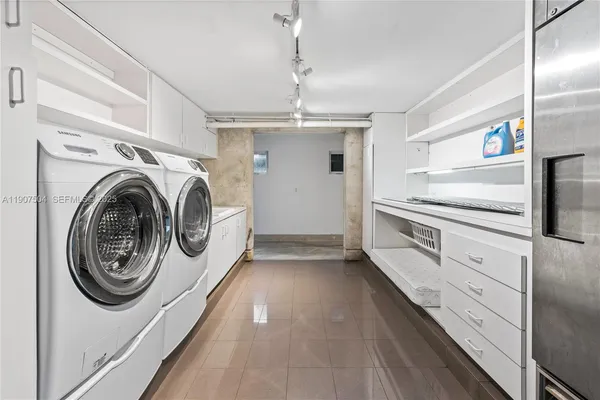 a large white kitchen with a large window