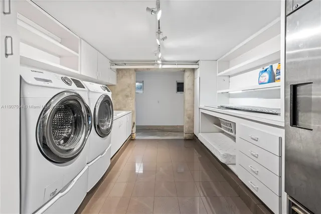 a large white kitchen with a large window