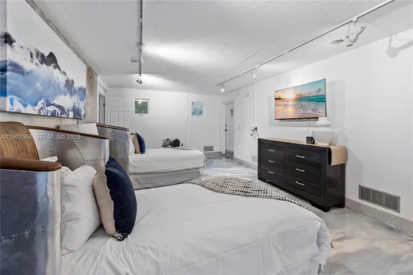 a bedroom with a bed and a painting on the wall