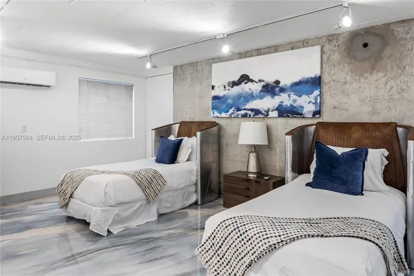 a bedroom with a bed and a dresser