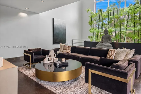 a living room with furniture lamp and window