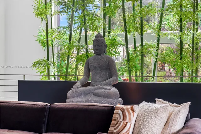 a living room with furniture and a floor to ceiling window