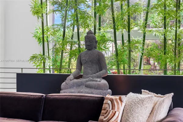 a living room with furniture and a floor to ceiling window