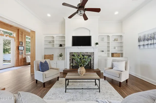 a living room with furniture a fireplace and a flat screen tv
