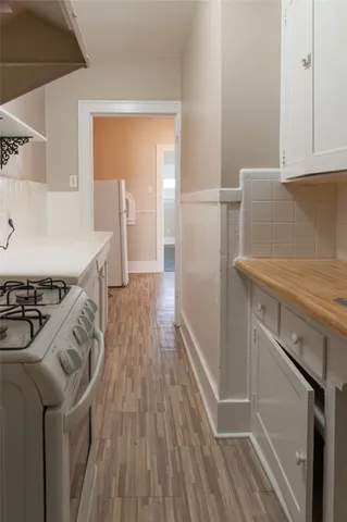 a view of hallway with wooden floor