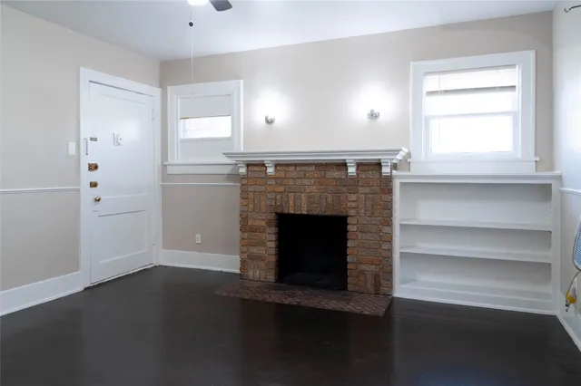 a living room with hard wood floors and a fireplace