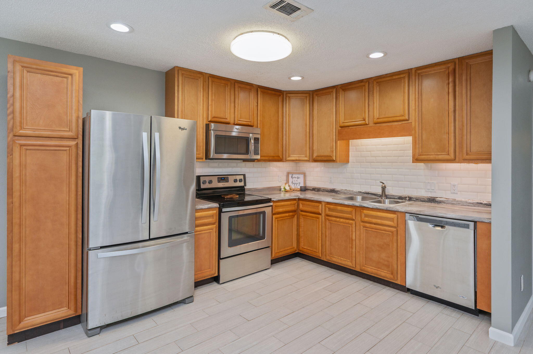 91 North Street DeFuniak Springs, FL 32433 - Photo 14 of 55 a kitchen with granite countertop stainless steel appliances a refrigerator cabinets and a sink