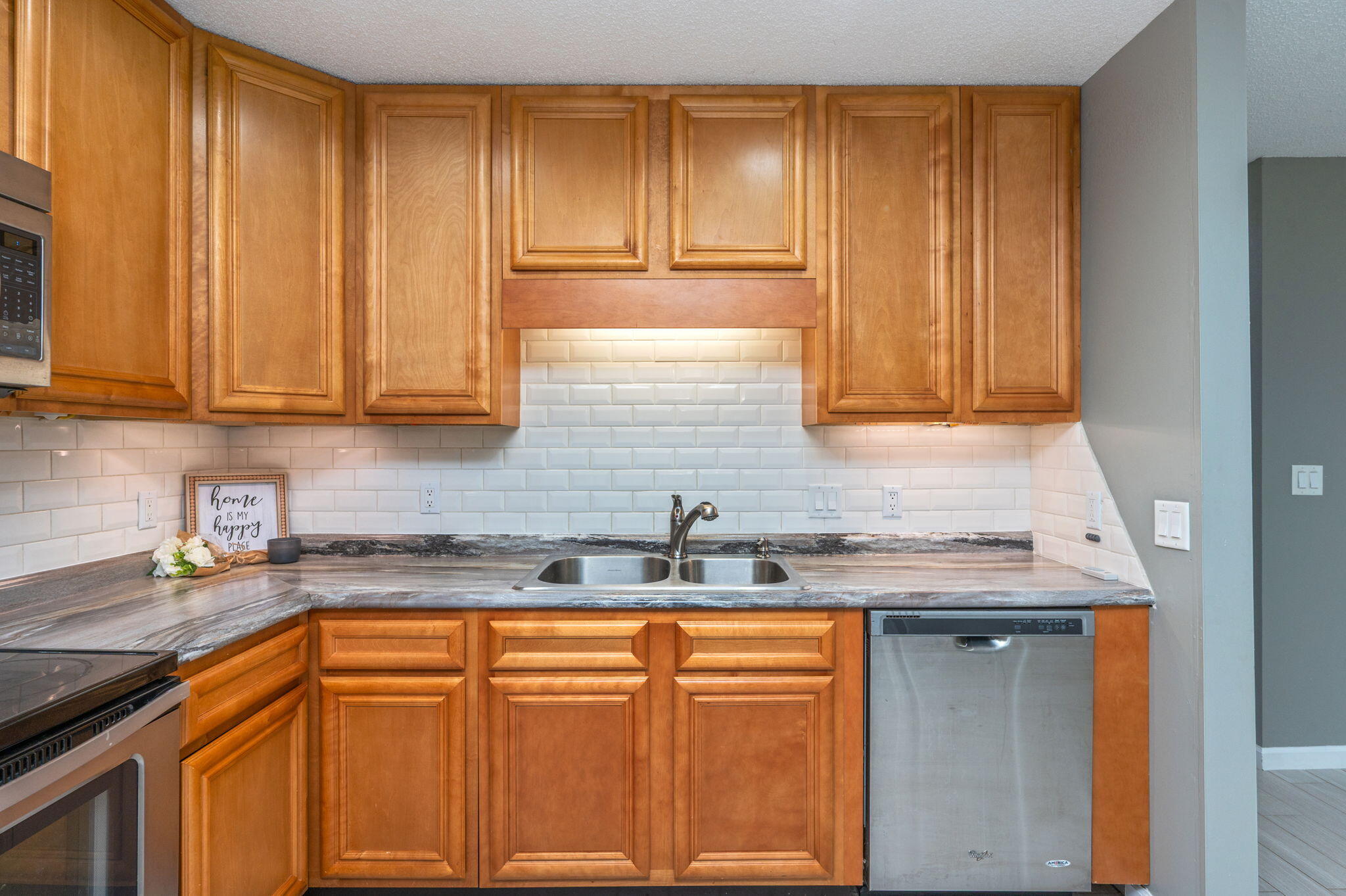 91 North Street DeFuniak Springs, FL 32433 - Photo 15 of 55 a kitchen with stainless steel appliances granite countertop a sink and cabinets
