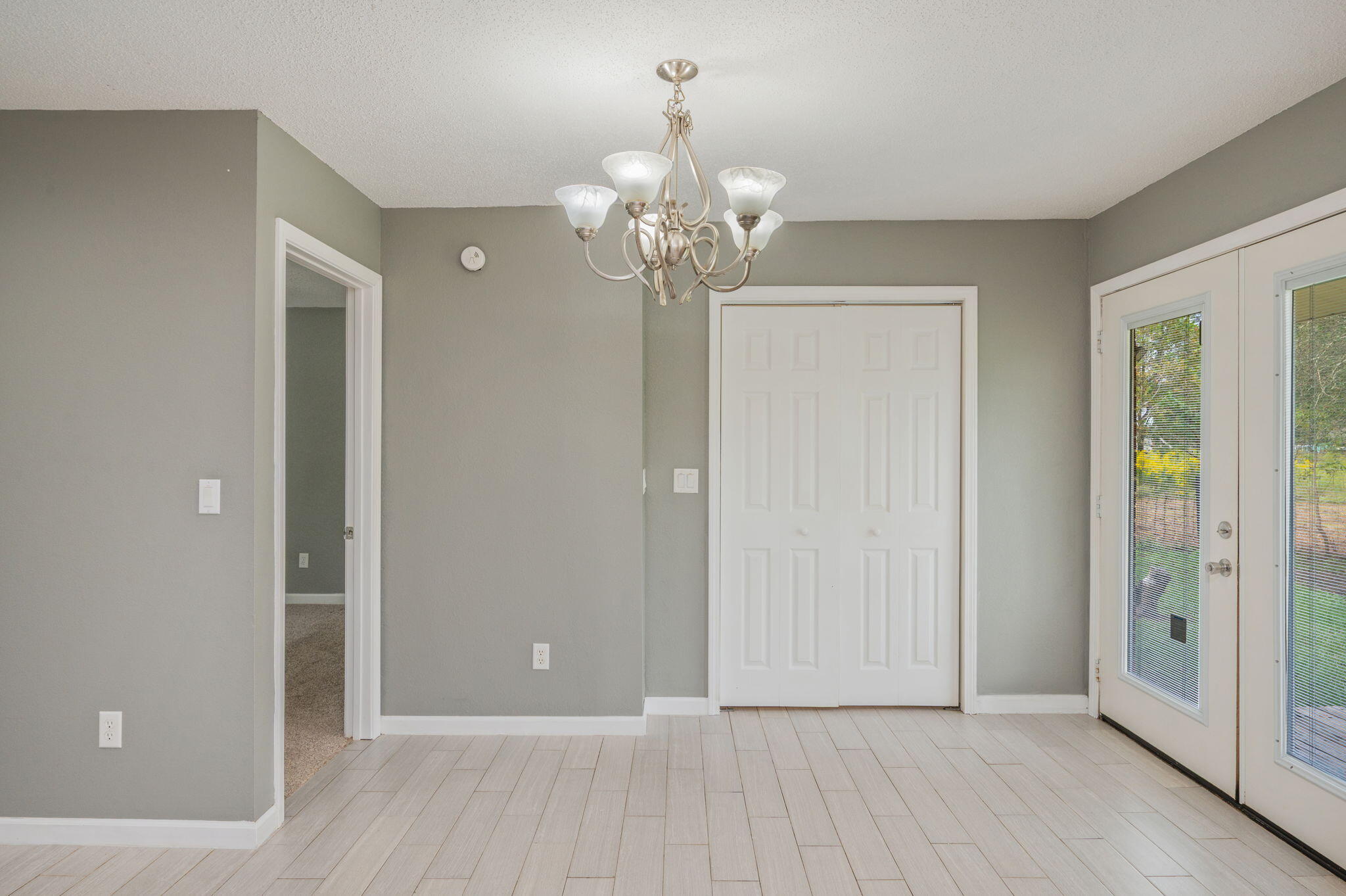 91 North Street DeFuniak Springs, FL 32433 - Photo 19 of 55 a view of an empty room with chandelier fan and wooden floor