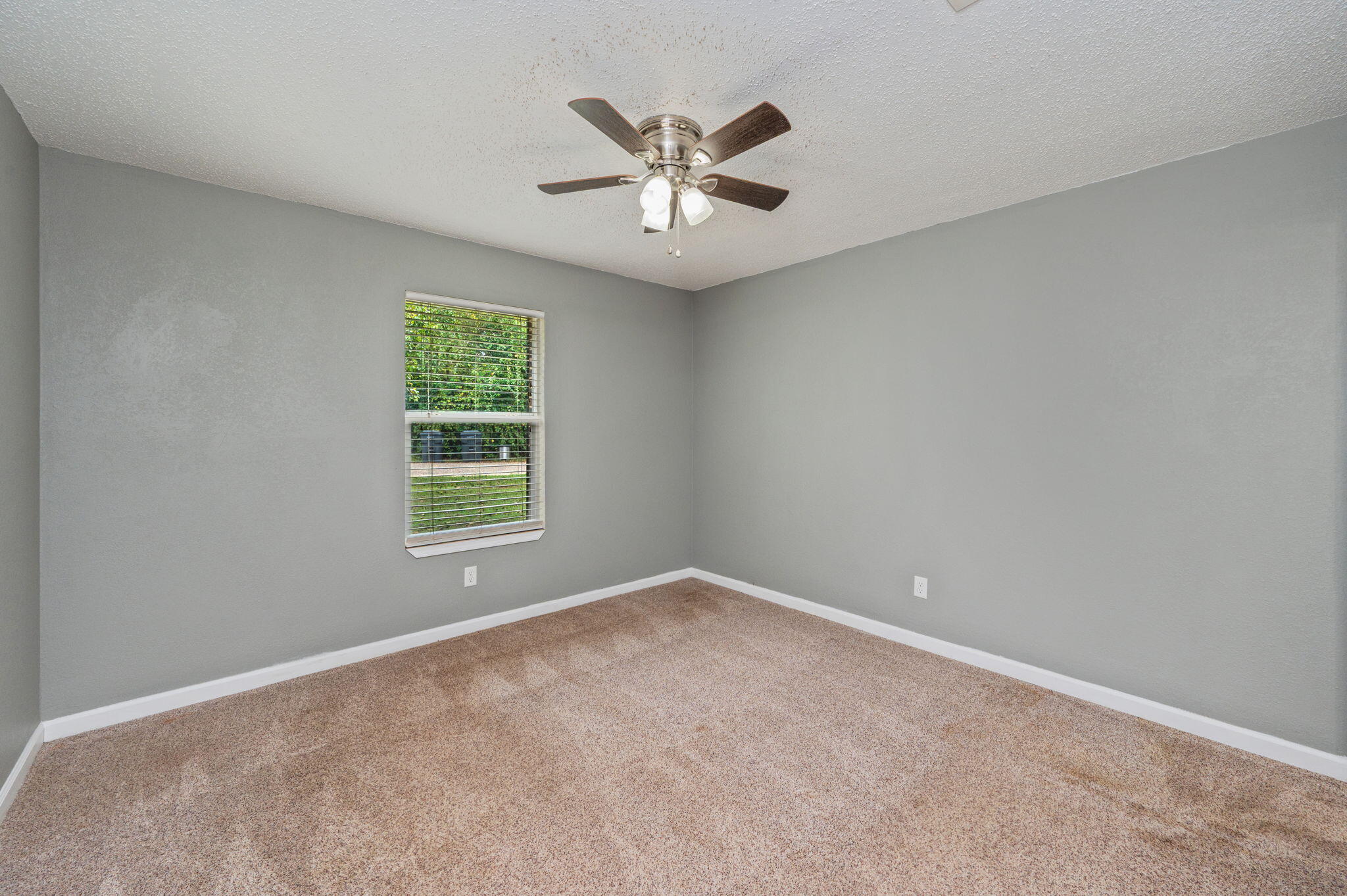 91 North Street DeFuniak Springs, FL 32433 - Photo 20 of 55 an empty room with a window and a ceiling fan