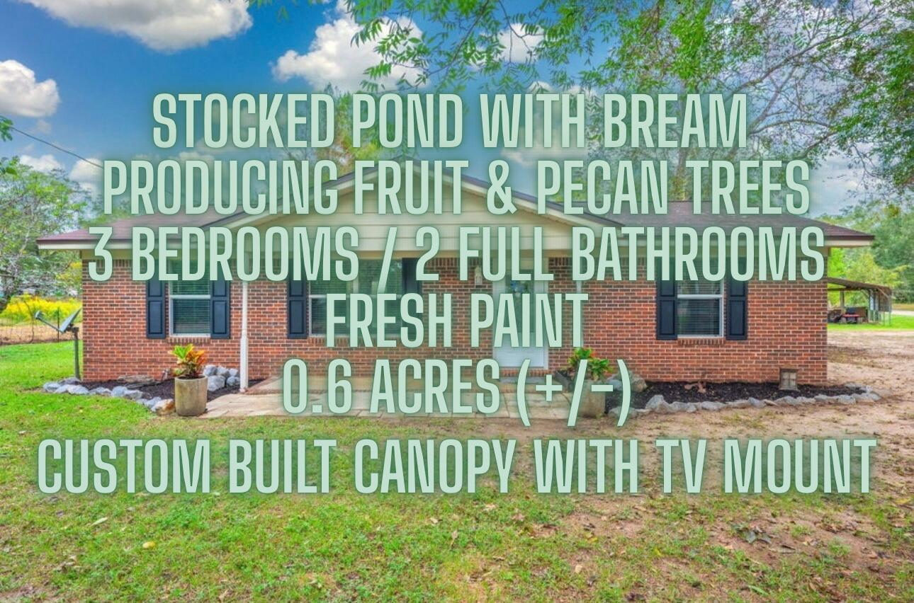 91 North Street DeFuniak Springs, FL 32433 - Photo 2 of 55 a view of a house with a small yard and trees