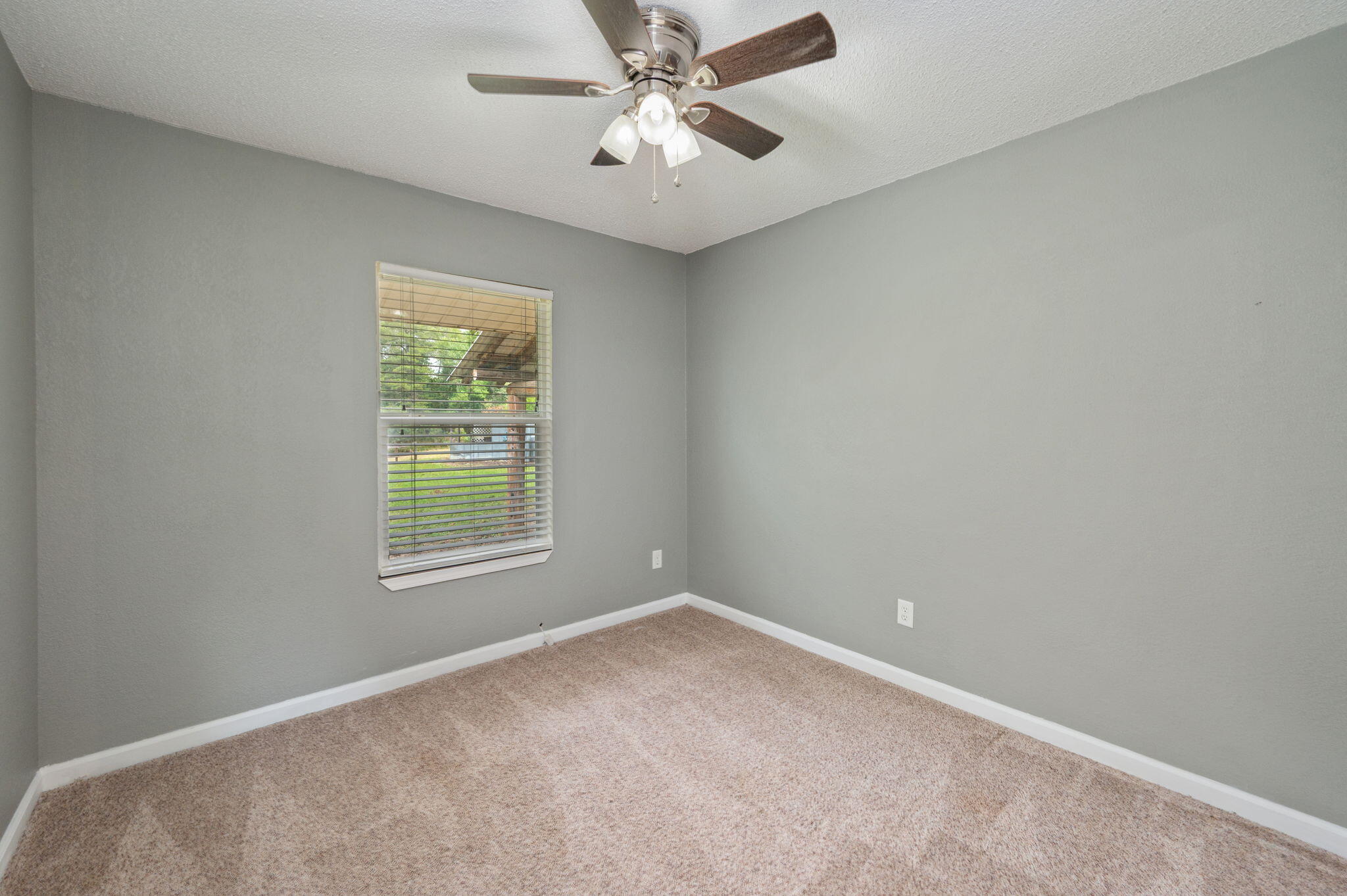91 North Street DeFuniak Springs, FL 32433 - Photo 27 of 55 an empty room with a window and a fan