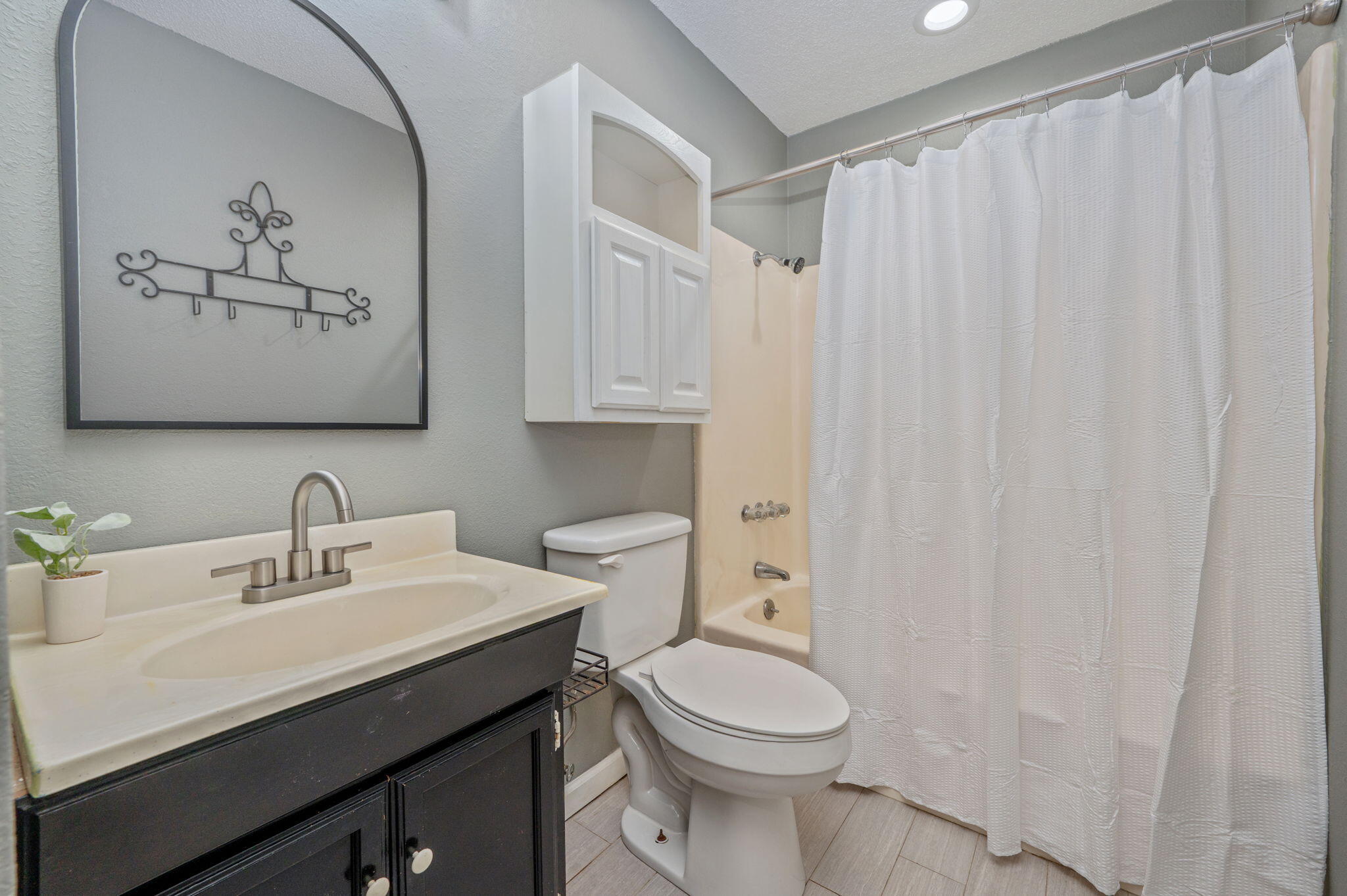 91 North Street DeFuniak Springs, FL 32433 - Photo 31 of 55 a bathroom with a toilet sink and mirror