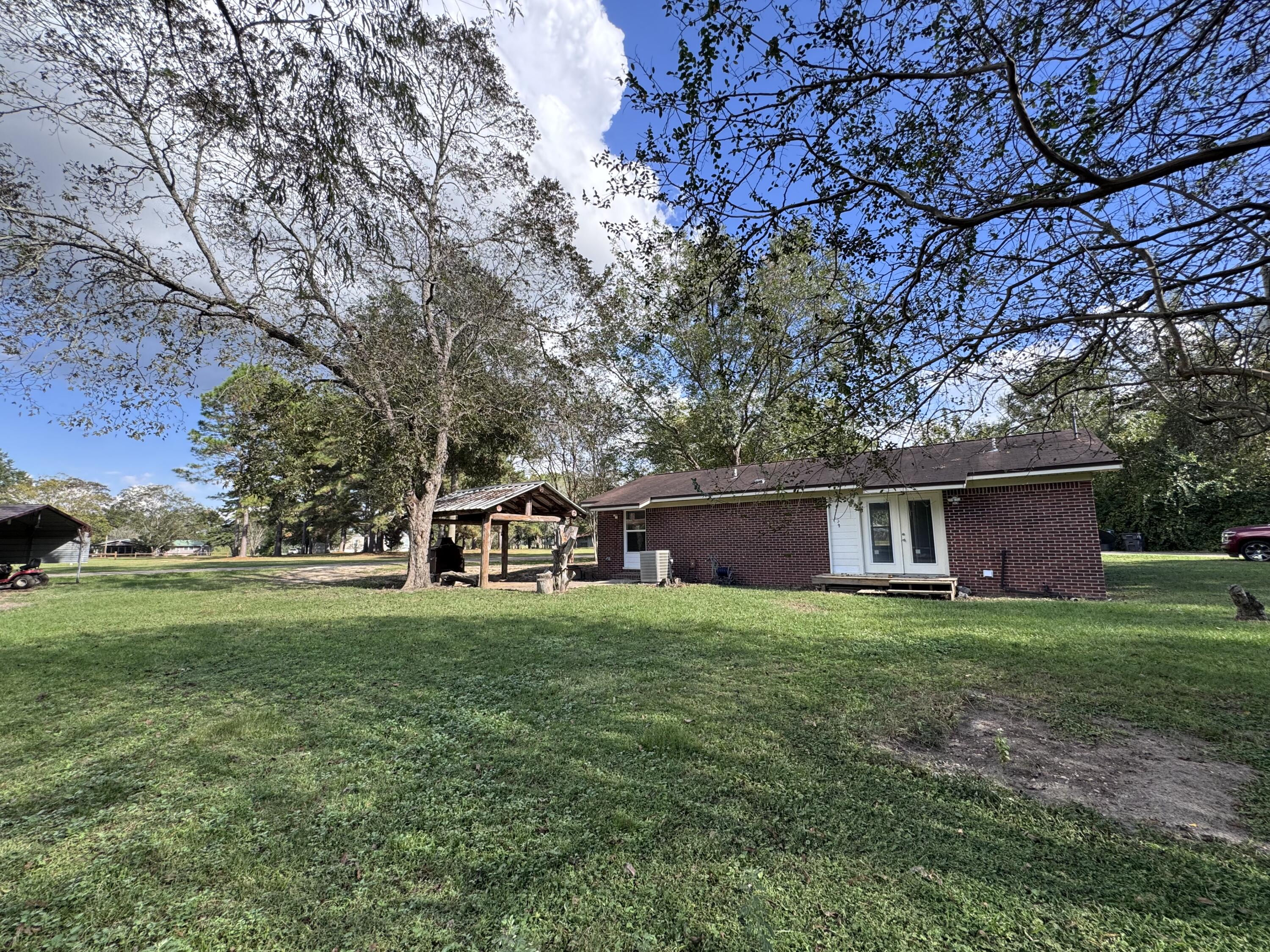 91 North Street DeFuniak Springs, FL 32433 - Photo 38 of 55 a view of a house with a big yard and large trees