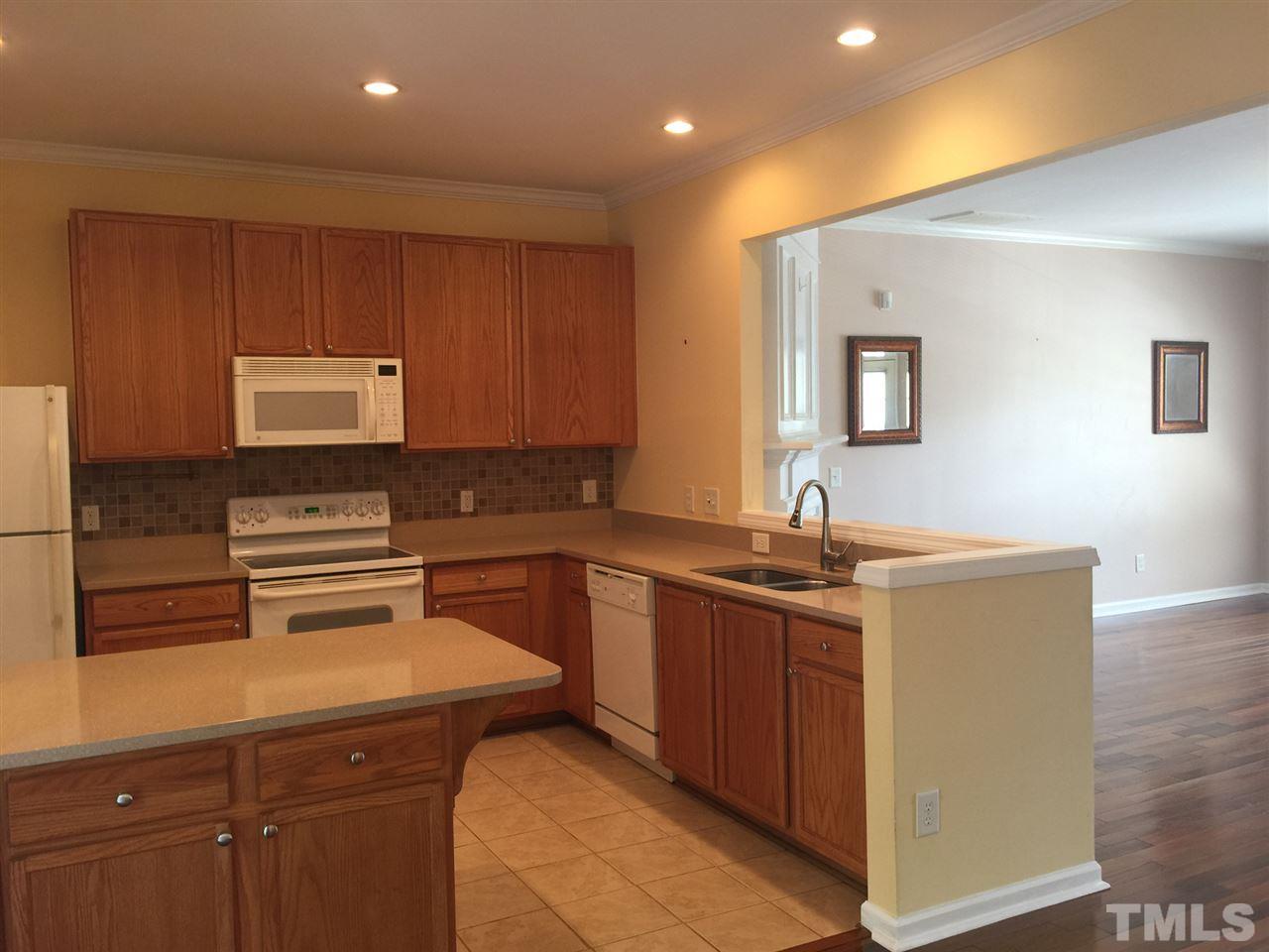 8520 Mt Valley Lane Raleigh, NC 27613 - Photo 3 of 10 a kitchen with a sink and a stove top oven
