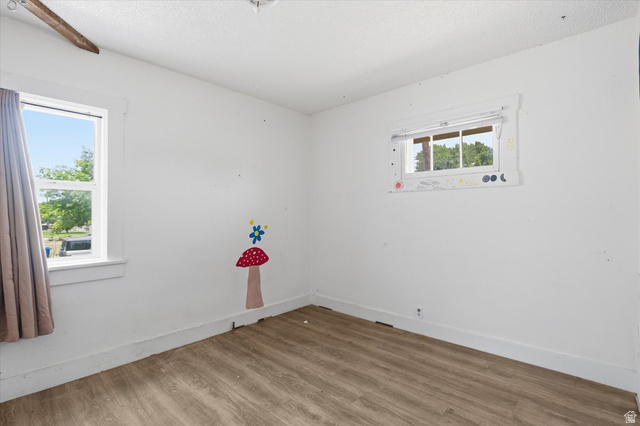 395 North 400 West Logan, UT 84321 - Photo 10 of 48 Bright room featuring two windows and wood-finish flooring