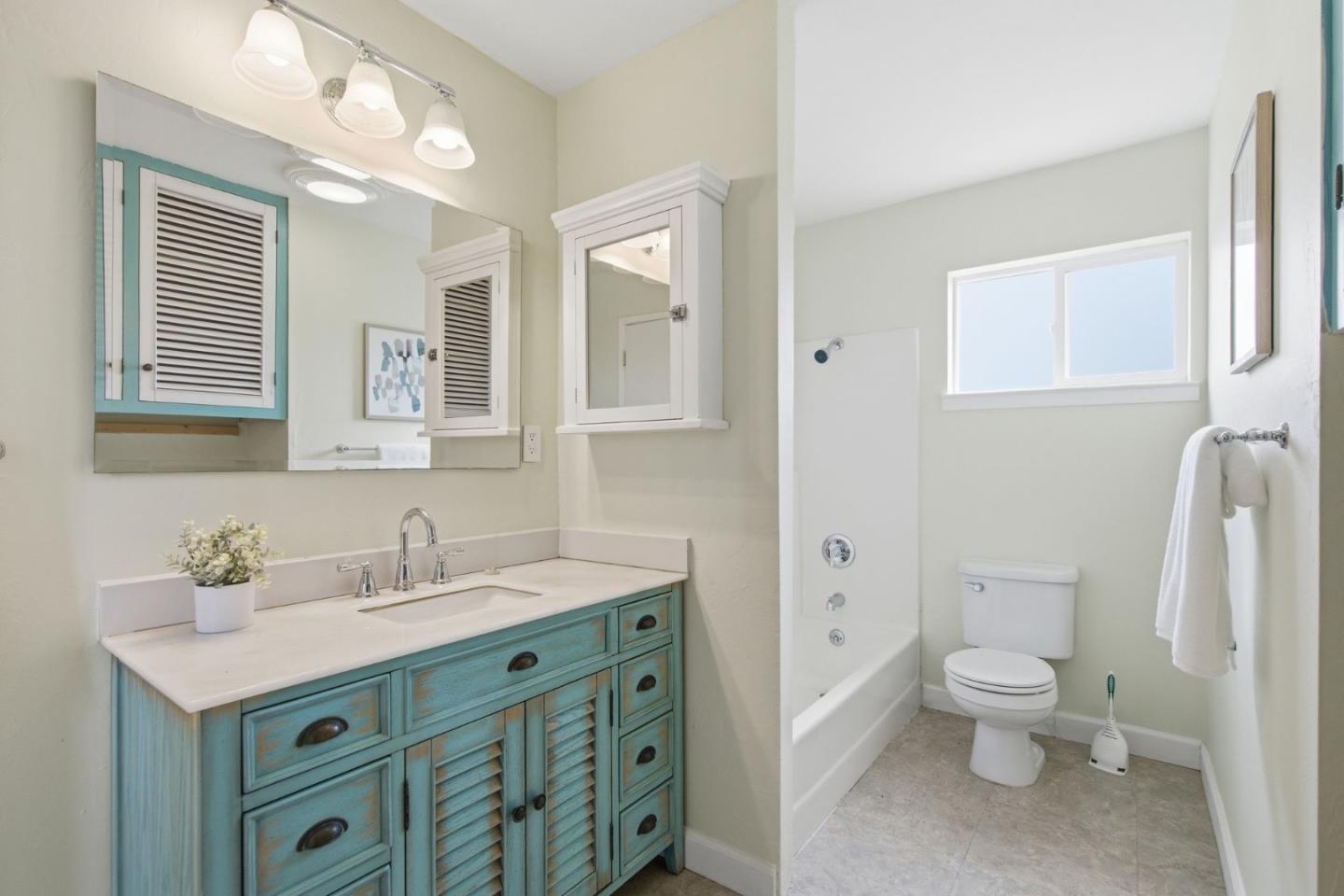 1263 Reservoir Road Pescadero, CA 94060 - Photo 62 of 66 a bathroom with a sink a toilet and a mirror