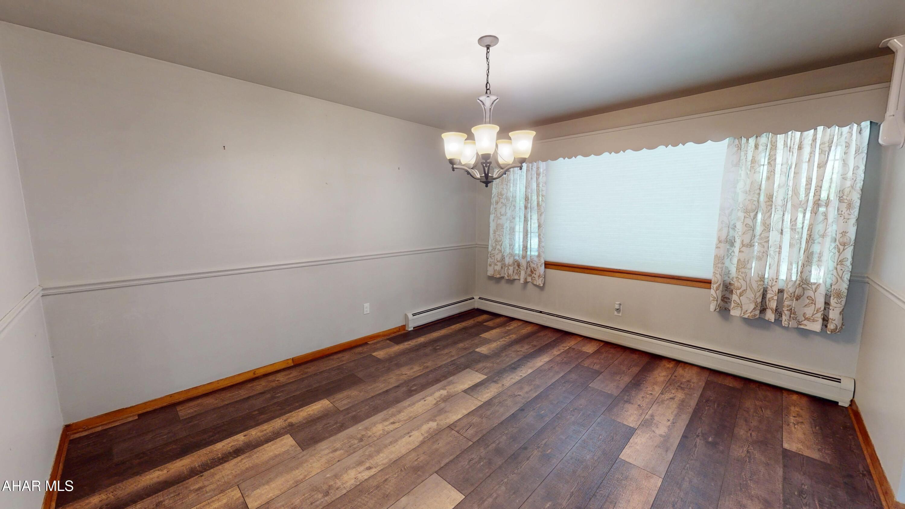 871 Decker Hollow Road Tyrone, PA 16686 - Photo 13 of 35 a view of an empty room with wooden floor and a window