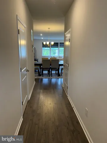a view of dining room with wooden floor and furniture