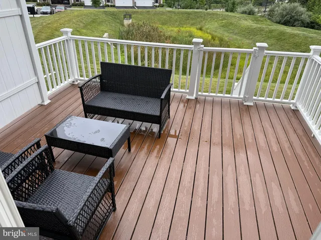 a view of a wooden deck with furniture